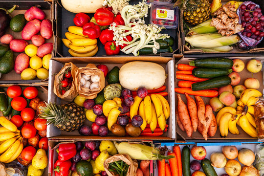 Colourful overhead angle of fresh organic fruit and vegetable boxes at unsupermarket food hub