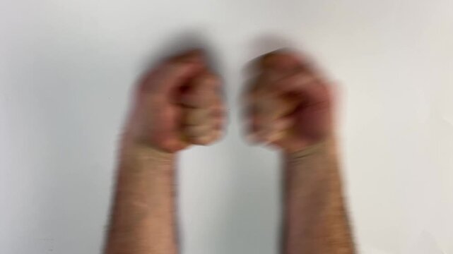 Two male fists hit each other together in a friendly gesture of greeting or agreement, isolated on a white background.