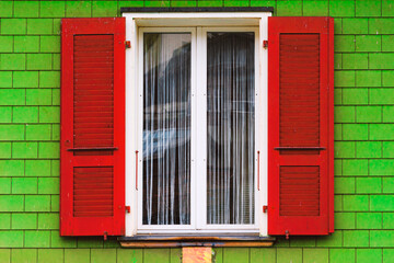 Obraz premium window with red shutters