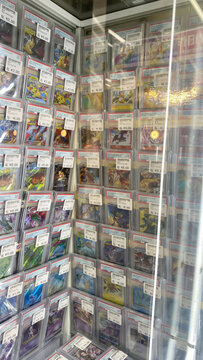 Hamburg, Germany - 04042026: retail display of Pok&eacute;mon trading cards inside a Japanese hobby shop. The image shows neatly arranged single cards in protective sleeves.