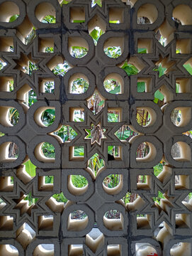 Ornamental Concrete Breeze Block Wall with Green Garden Background