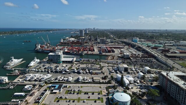 Riviera Beach, United States - 15 April 2026: Aerial view of the industrial port and marina with cargo ships, luxury yachts, and coastal infrastructure under a bright blue sky.