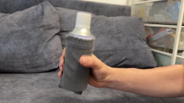 Hand shaking bottle of liquid cleaner or cosmetic product