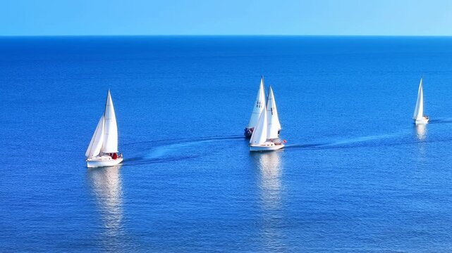 Calm Sea Voyage. Boats Sail Under Bright Sky. Sundrenched Boats Drift Smoothly Across Water