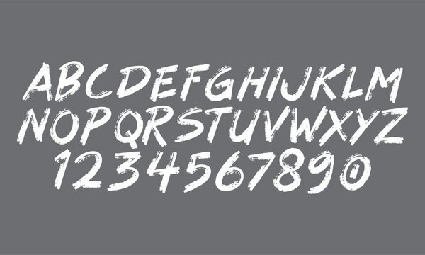 White hand drawn brush alphabet and numbers set on grey background for creative graphic design typography posters and branding
