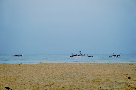 Fishing boats in the sea off Colva beach in Goa, India