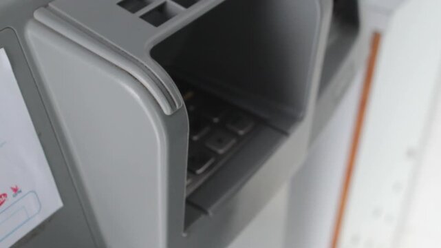 Hand Entering PIN Code on ATM Machine Security Concept