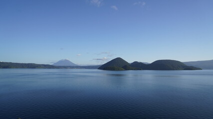 Morning view of Lake Toya with volcanic islands and Mt. Yotei, Hokkaido, Japan © tomoko