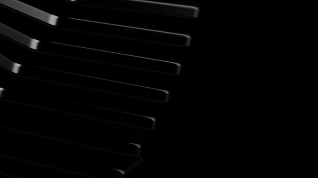 Close up view of dark modular architectural steps featuring a spiral descent with subtle highlights on black surfaces creating a sense of depth and mystery