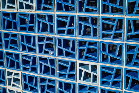 Blue geometric breeze block wall pattern