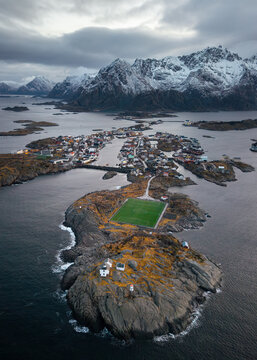 Island village with a soccer field among mountains