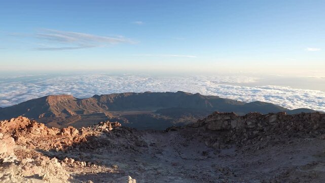 Volcanic crater landscape view above clouds at sunrise