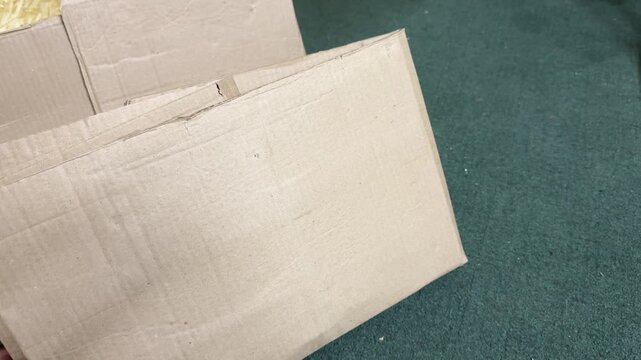 Flat cardboard box placed on floor ready for packing or storage