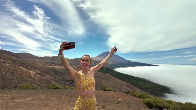 Influencer woman taking a selfie with teide volcano