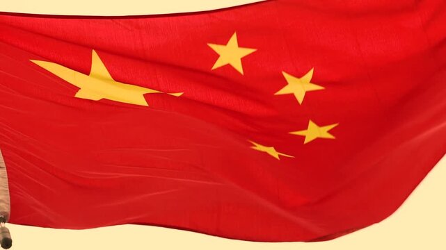 Red Chinese flag waving in wind dynamic video footage close up