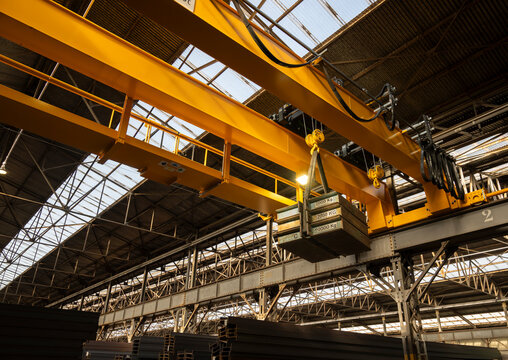 Heavy load suspended from overhead crane during industrial lifting operation
