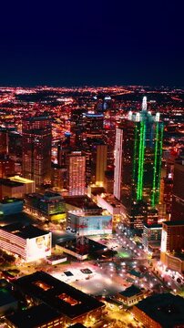 Luminous scenery of Dallas, Texas, USA at night. Splendid panorama of metropolis from drone. Vertical video