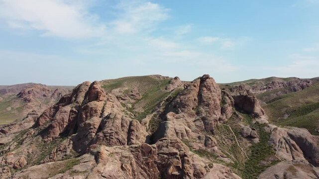 Aerial 4K view of Ili River and sacred Tamgaly Tas petroglyphs in Kazakhstan steppe
