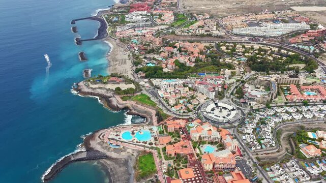 Aerial view of Costa Adeje Coastline covred in mega resorts and hotel by the beach in Tenerife South