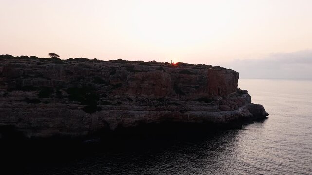 Golden hour illuminates the dramatic cliffs of calo des moro, mallorca, at sunrise