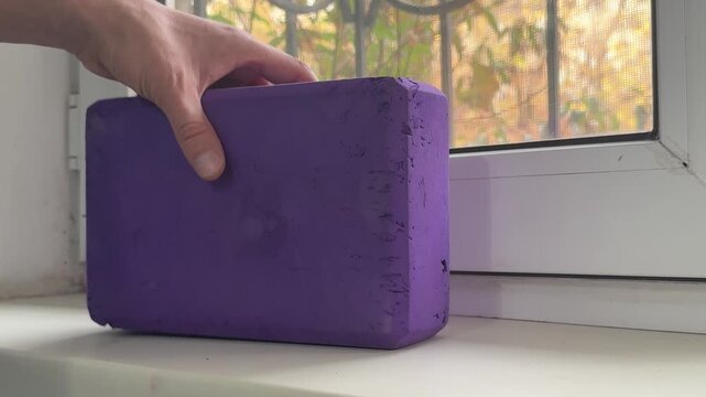 Throwing a yoga block onto a windowsill