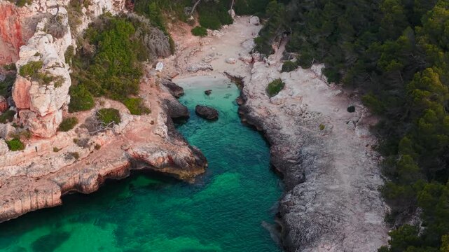 Turquoise water flows into calo des moro beach, a beautiful cove in mallorca