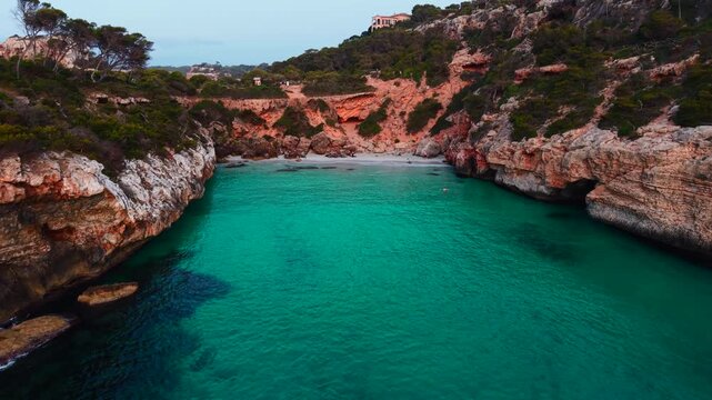 Breathtaking calo des moro beach in mallorca, spain, captivates with turquoise waters and dramatic cliffs