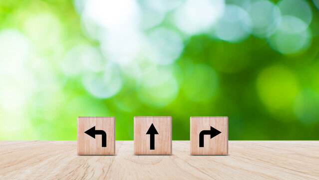 Arrows on wooden with three direction arrow choices, left, right or move forward, difficult decision making concept, Motivation and growth. not ai
