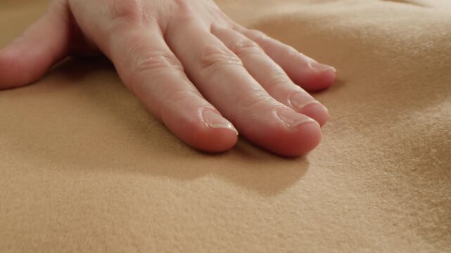 Beige wool background, natural sheepskin close-up macro coat. Top view