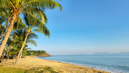 Mae Nam Beach with palm trees in the light of sunset, Island Ko Samui, Surat Thani, Thailand. © Iryna Shpulak