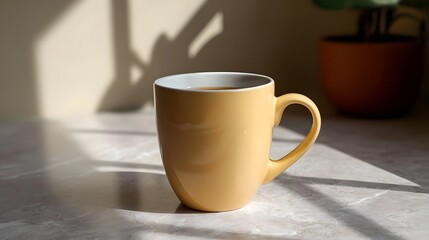 Obraz premium A warm beige ceramic mug is captured on a light textured surface dramatically illuminated by harsh directional sunlight casting defined shadows