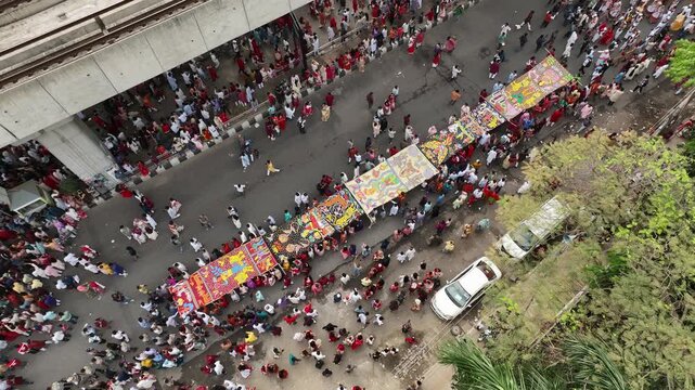 A vibrant sea of people celebrates the Bengali New Year as the colorful Mangal Shobhajatra procession winds through the streets of Dhaka.