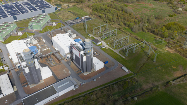 Hamm, Germany: Aerial view of Trianel Gaskraftwerk Hamm GmbH Co. KG, a gas-fired power plant with cooling towers and industrial buildings surrounded by green fields.