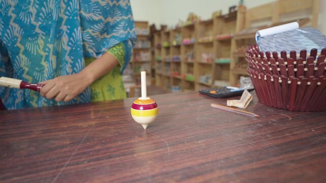woman spinning a top (toy) broll