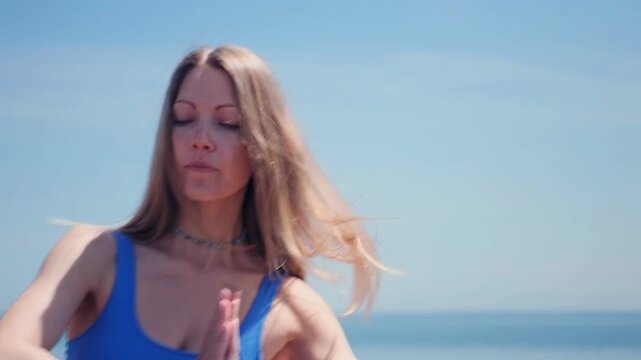 woman performing yoga flow sequence on mat at wooden pier by lake, sea, moving through bridge, downward dog, child pose and balance positions, stretching body and relaxing in calm outdoor environment