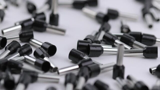 Metal tips with a plastic base for mounting on stranded copper wires. Close-up. Soft focus. Macro.