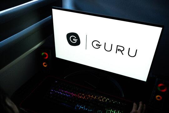 Punta Arenas, Chile &ndash; April 27, 2026: The Guru enterprise AI search and knowledge management logo shown on a PC monitor with an RGB mechanical keyboard