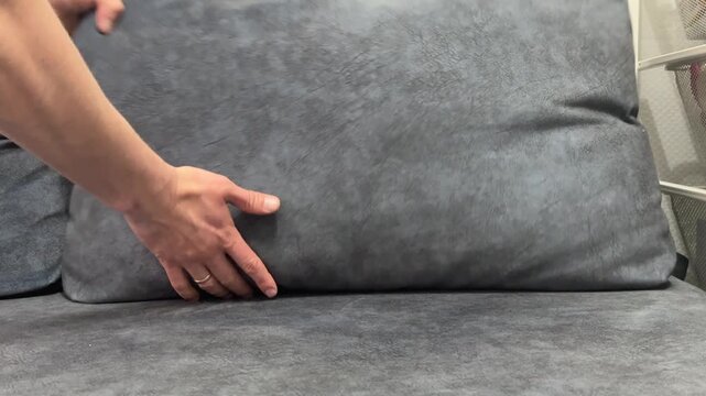 Tossing a pillow back onto a couch