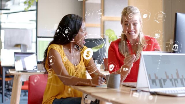 Women reviewing laptop charts, left speaking and pointing, HUD tracking gestures $ icon for finance