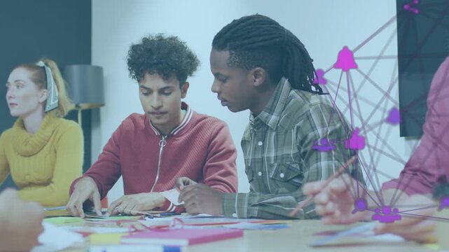 Two men assembling paper after design prompt, aligning cutouts as purple network growing by hands