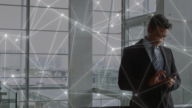 Vertical video: Businessman shifting, tapping phone to check flight info, network spanning glass