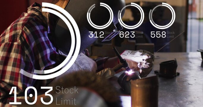 Welding helmeted welder in plaid leaning over workbench, metal shop, holding torch, filler rod, HUD