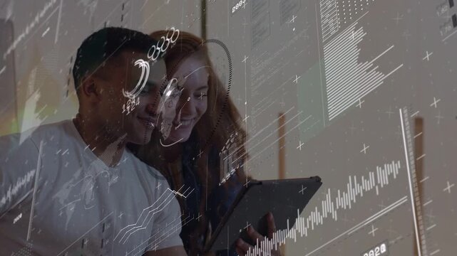 Man seated tapping tablet causing tech AR charts and data, woman leaning, viewing content together