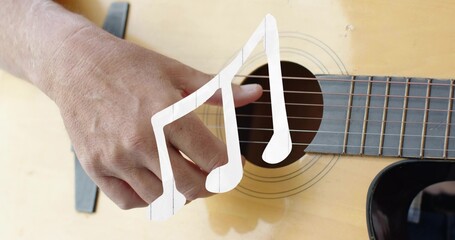Fototapeta premium Plucking bare forearm and hand over acoustic guitar rosette in studio, with capo and note overlay