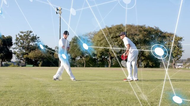 2nd player walking to center placing orange cones for cricket while blue net overlay linking cones