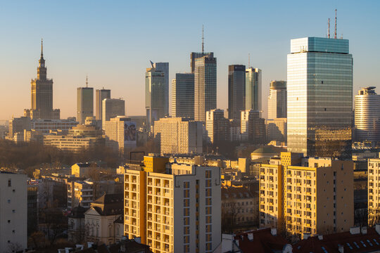 Warsaw, Poland - 07 March 2026: Aerial view of the Palace of Culture and Science and modern skyscrapers under a warm golden hour light in the city center.