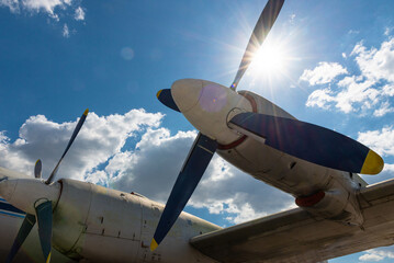 Airplane propeller silhouette against sun and blue sky © Aliaksandr