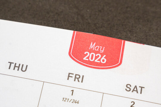 A close-up view of a May 2026 calendar page, displaying days of the week. The bold red header contrasts with a neutral background, suitable for planning or organization themes.