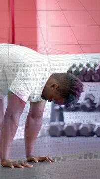 Vertical video: Man placing hands practicing hand-balance in gym while overlay scrolling over hands