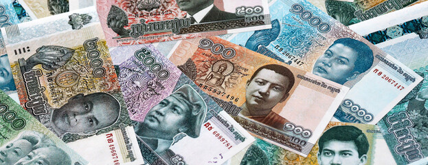 Cambodian riel money banknotes pile on table. Cambodia bills of KHR currency close up © Larysa